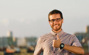 Positive professional man doing thumbs up gesture clipart