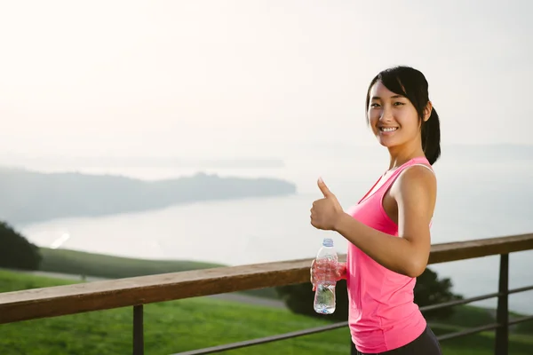 Positivo deportivo mujer haciendo pulgares hacia arriba gesto Fotos De Stock Sin Royalties Gratis