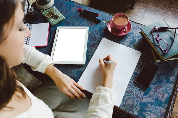 Woman writing and working at home