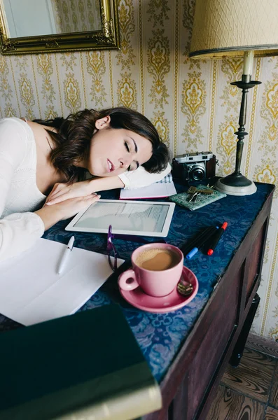 Exhausted home worker woman sleeping on desk — Stok fotoğraf