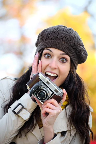 Surprised woman taking photos in autumn — 图库照片