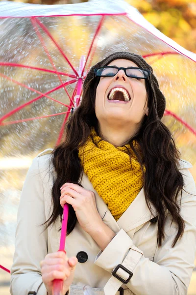 Woman with umbrella having fun in autumn Stock Image
