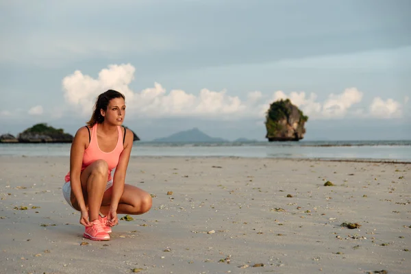 Female athlete ready for running at beach — Stock Photo, Image