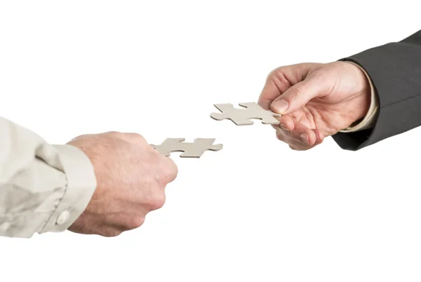 Two hands coming from opposite directions matching two puzzle pi — Stock Photo, Image