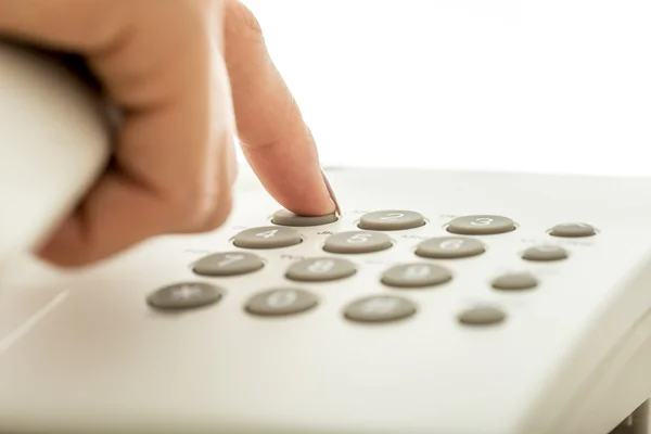Closeup of female hand dialing a telephone number — Stock Photo, Image
