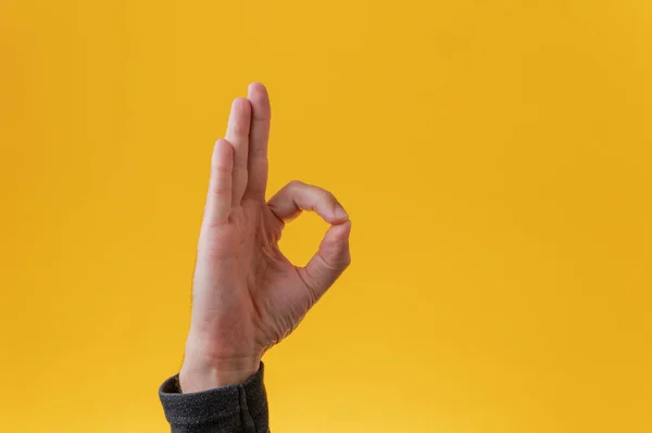 Male Hand Making Gesture Yellow Background — Stock Photo, Image