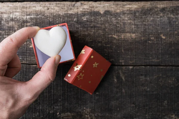 Male Hand Placing Heart Shaped White Marble Tiny Gift Box — Stock Photo, Image