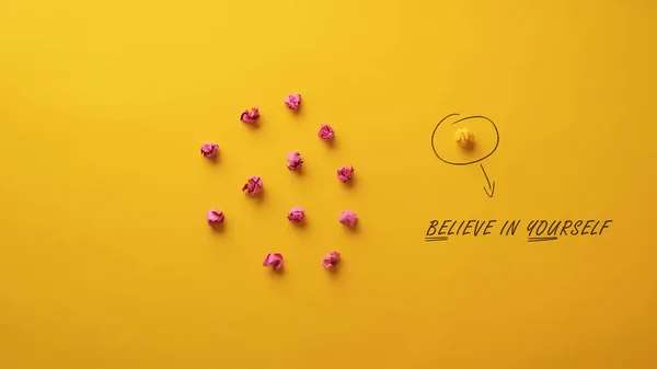 Believe in yourself message spelled on yellow background in conceptual image of individuality and courage.