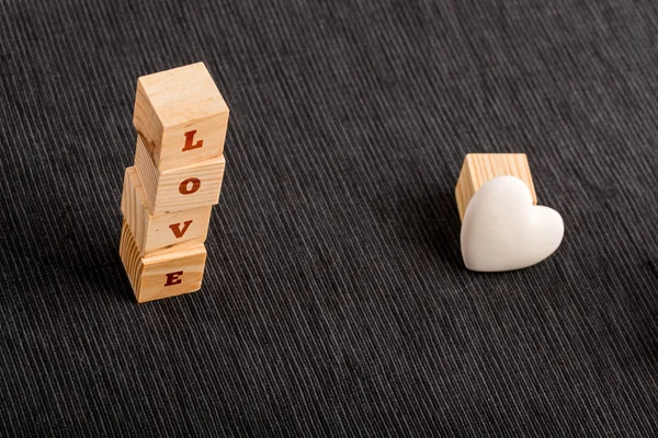 Letter Blocks Spelling LOVE Beside White Heart — Stock Photo, Image