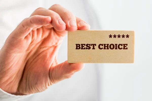 Man holding a wooden rectangle saying Best Choice — Stock Photo, Image