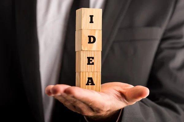 Businessman holding cubes with the word Idea — Stock Photo, Image