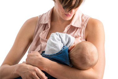 Devoted young mother breastfeeding her newborn baby clipart
