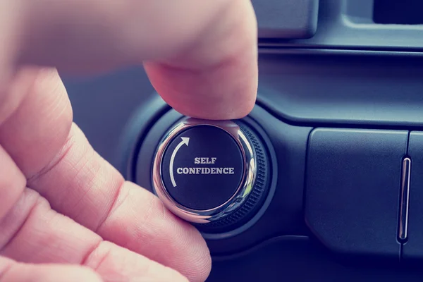 Man turning up a dial reading - Self Confidence — Stock Photo, Image