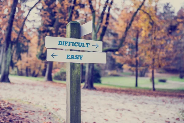 Opposite directions towards difficult and easy — Stock Photo, Image