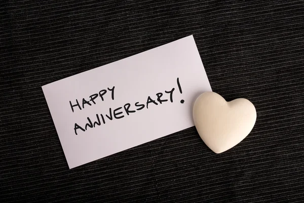 Happy anniversary handwritten on a white card — Stock Photo, Image