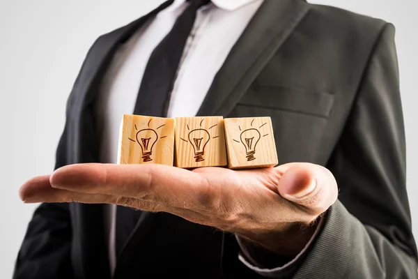 Wooden cubes with incandescent light bulbs — Stock Photo, Image