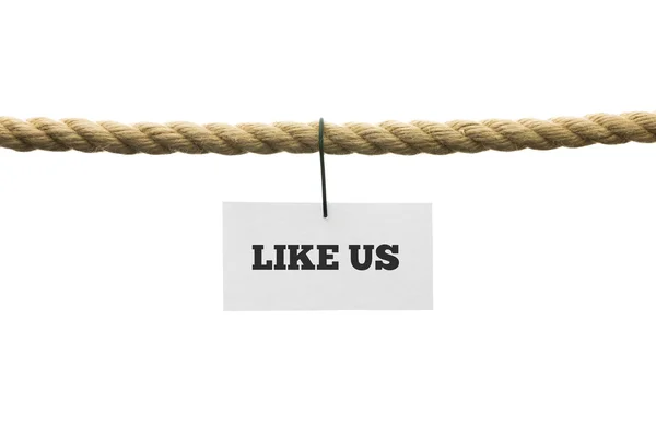 White card with Like us text hanging by wire from a rope — Stock Photo, Image