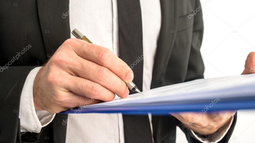 Business man signing a contract or document on a map