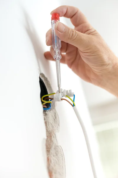 Electrician checking electric voltage — Stock Photo, Image