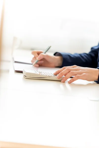 Businesswoman Calculating Sales Using Calculator Stock Image