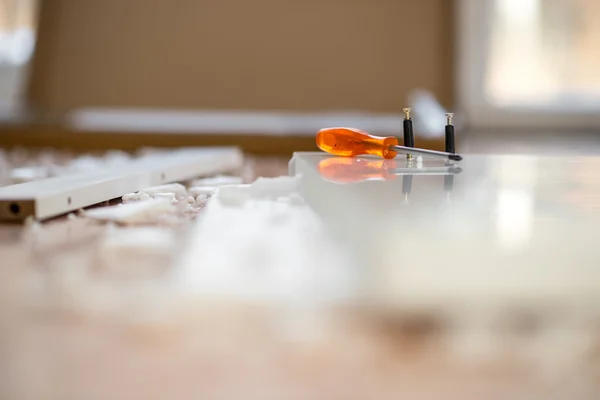 Screwdriver lying on a work bench in a DIY concept — Stock Photo, Image