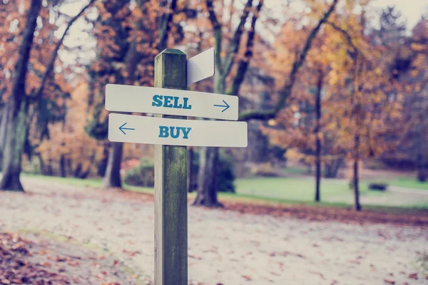 Opposite directions towards Sell and Buy — Stock Photo, Image