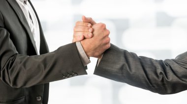 Conceptual Business Partners Gripping their Hands clipart