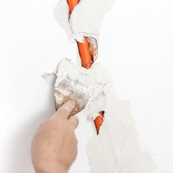 Plastering Flexible Corrugated Cable Duct into the wall — Stock Photo, Image