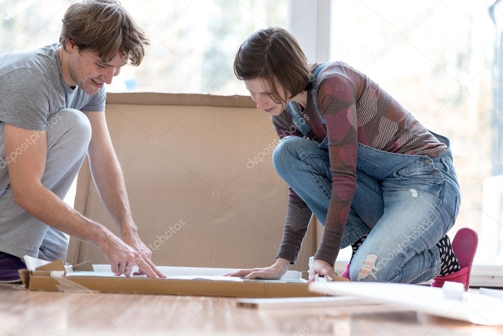 Young couple putting together new furinture