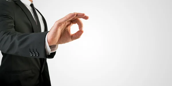 Businessman in OK Hand Sign on Grey Background — Stock Photo, Image