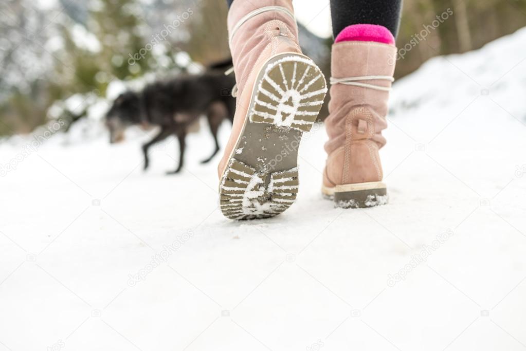 Winter Shoes of a Woman Walking on the Snow