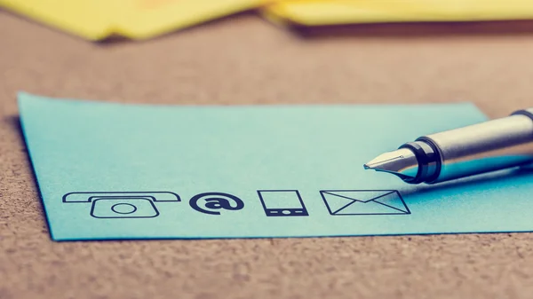 Four Contact Icons Printed on a Light Blue Paper — Stock Photo, Image