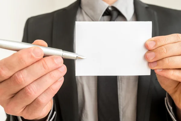 Empresario con una tarjeta en blanco y bolígrafo —  Fotos de Stock