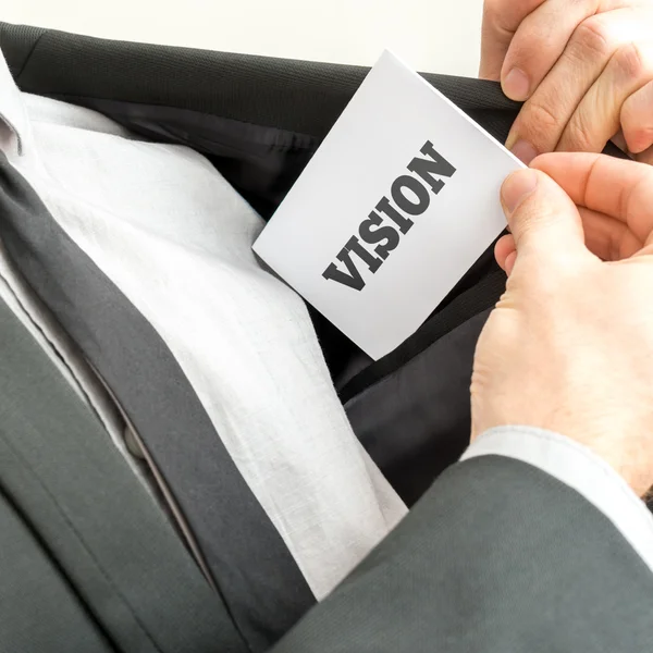 Businessman removing or placing a card with word Vision — Stock Photo, Image