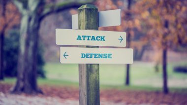 Rustic wooden sign in an autumn park with the words Attack - Def clipart
