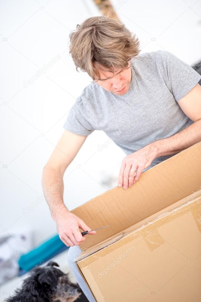 Man unpacking a cardboard carton