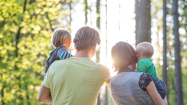 Young parents holding their babies — Stock Photo, Image