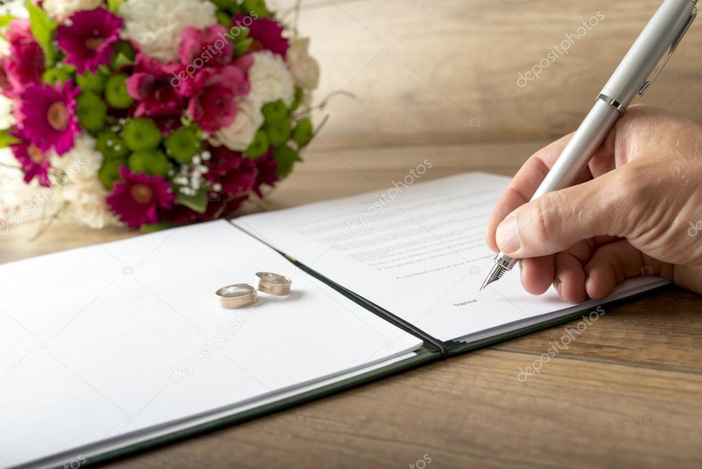 Man signing a marriage register