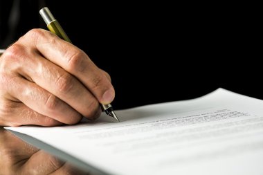 Male hand signing a contract, employment papers, legal document  clipart
