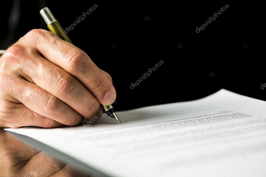 Male hand signing a contract, employment papers, legal document 
