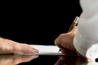 Businessman or attorney  signing a document,  contract or legal 