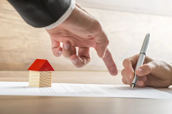 Real estate agent showing his client where to sign a contract of — Stok fotoğraf