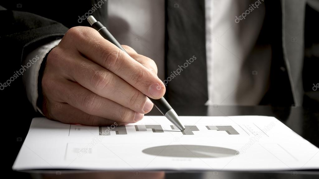 Financial consultant reviewing statistical graphs and charts