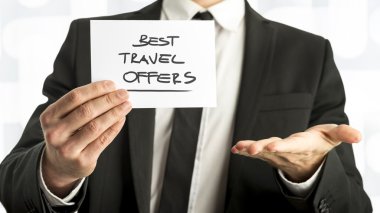 Businessman with Best Travel Offers Texts on Paper