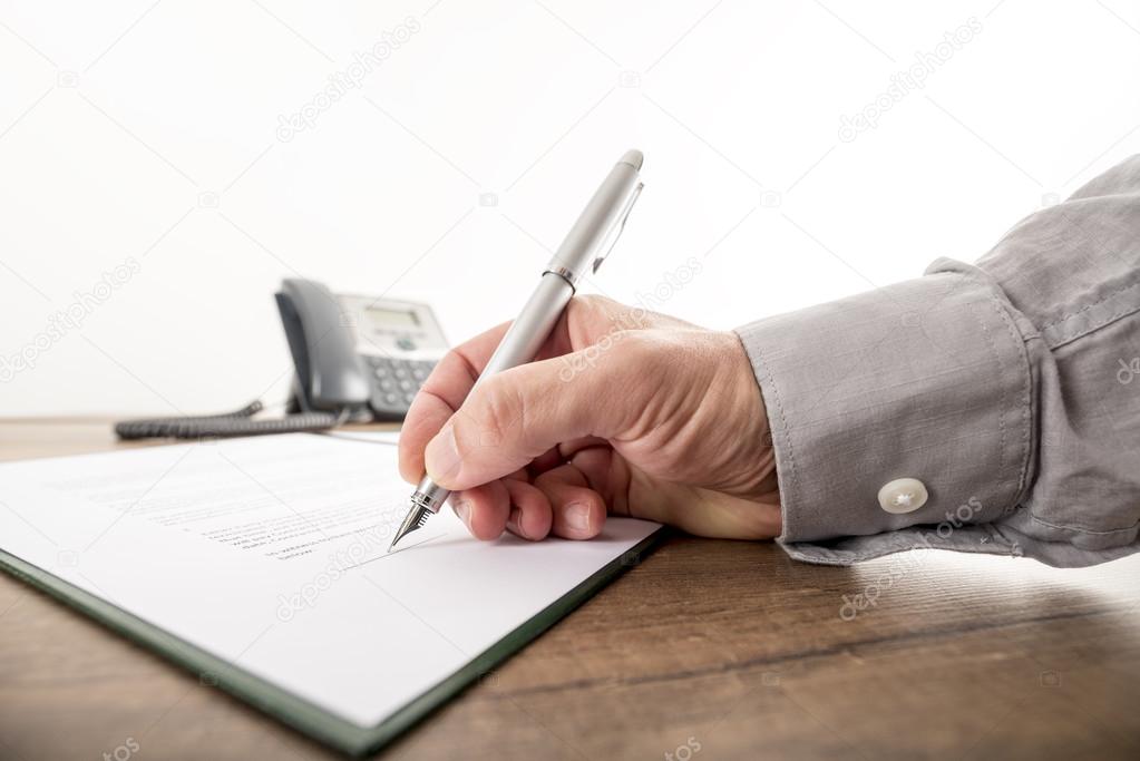 Closeup of businessman or lawyer signing an important contract, 