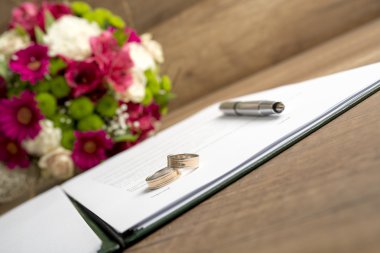 Wedding Register with Pen, Bride and Groom Rings and Bouquet of 
