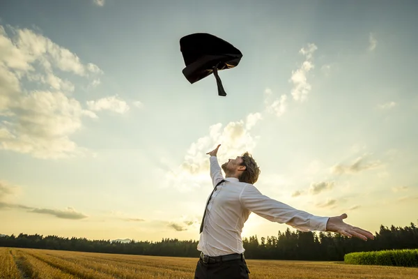 Feliz hombre de negocios lanzando su abrigo por ser libre —  Fotos de Stock