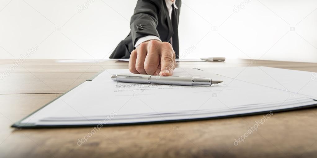 Front view of a businessman offering you to sign a document or c