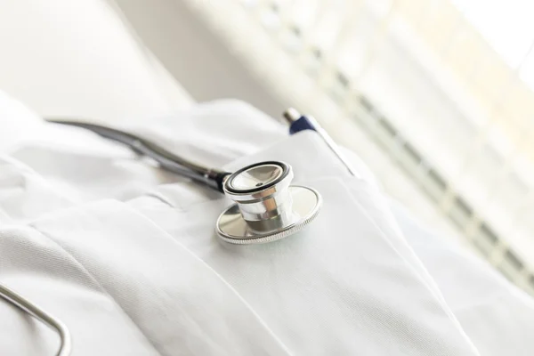 Stethoscope on a white lab coat — Stok fotoğraf