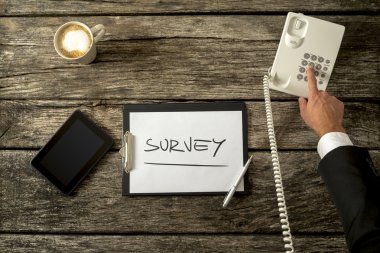 Overhead view of telephone operator making survey on the phone 